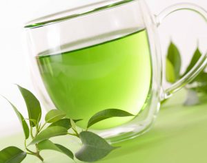 healthy green tea cup with tea leaves