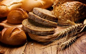 assortment of baked bread on wood table